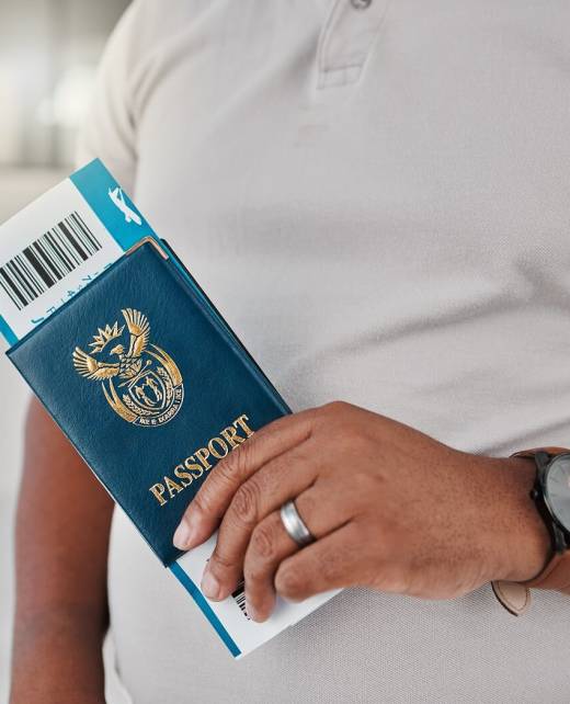 man-at-airport-with-passport-travel-visa-and-tick-2023-11-27-05-00-30-utc (1)